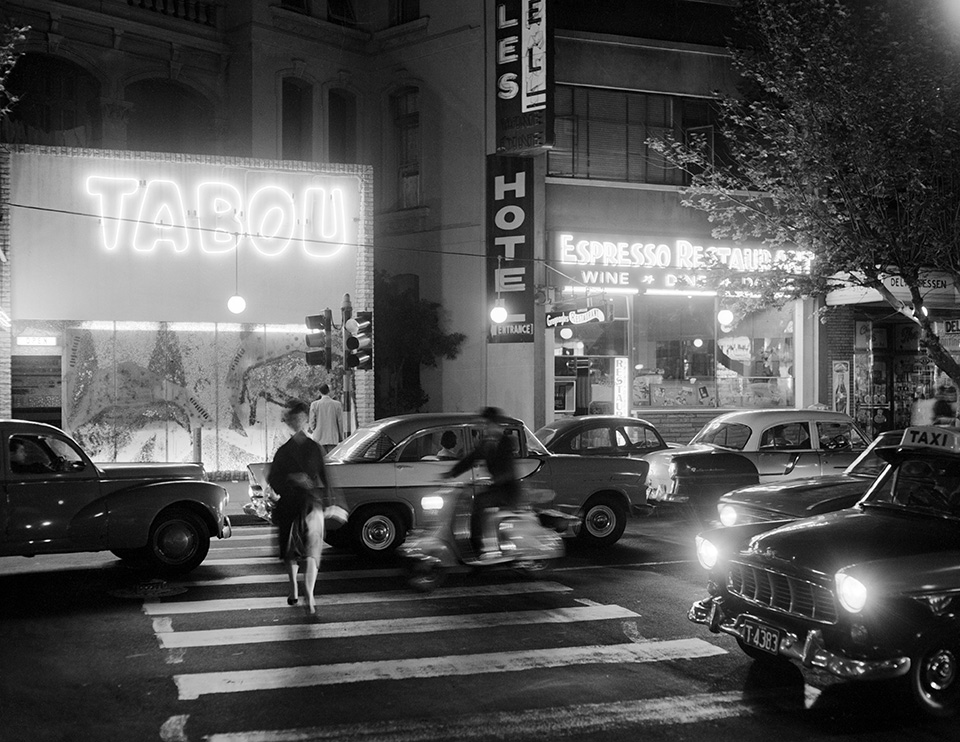 Pedestrian crossing Darlinghurst Road outside the Tabou nightclub at night,  Kings Cross 1961